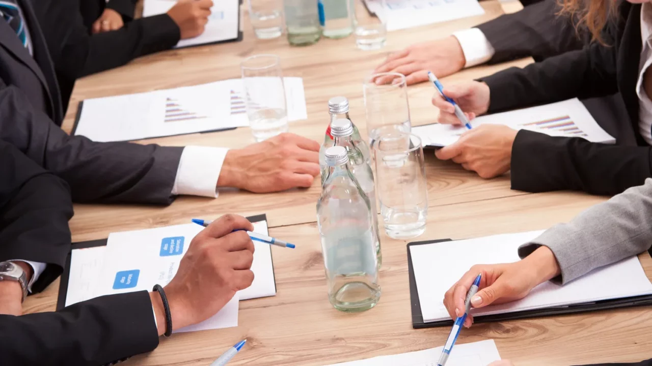 Cropped view of business people's hands in the meeting.