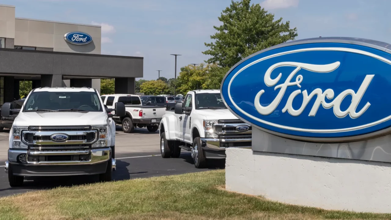 Shot of Ford dealership and cars parked.